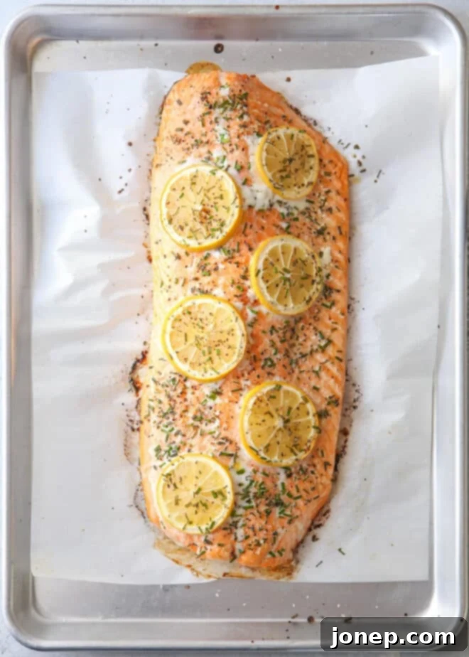 Easy Lemon Herb Roasted Salmon 5 Perfectly roasted salmon with lemon and herbs on a sheet pan, just out of the oven.