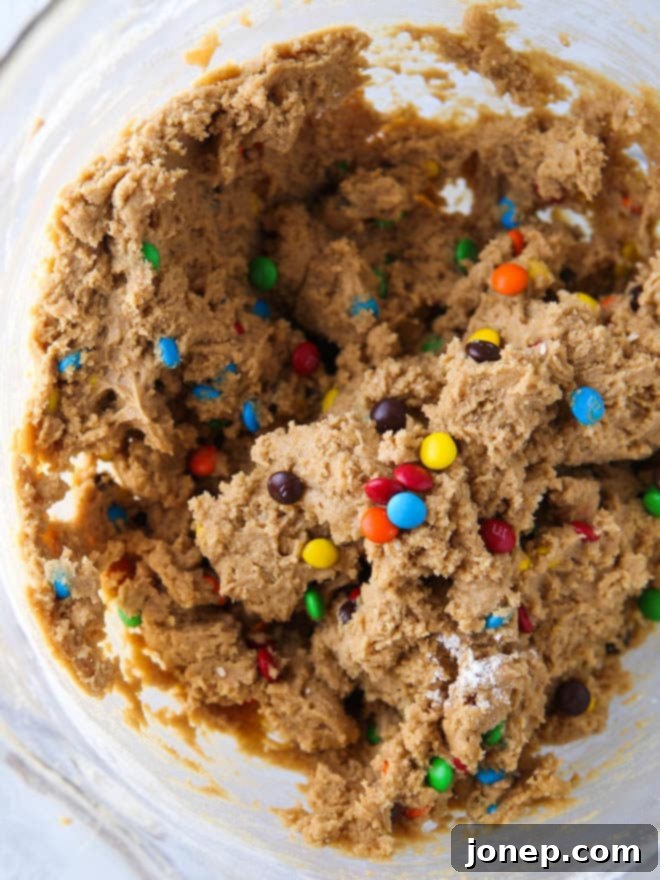 Close-up of baked Peanut Butter M&M Cookie Bars in a pan