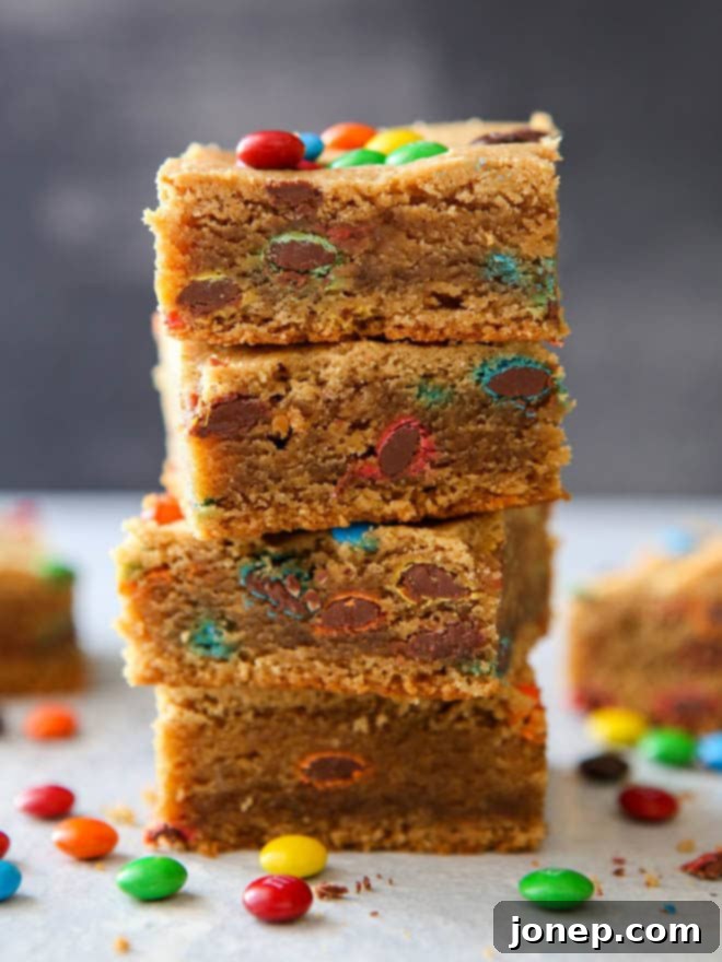 Sliced Peanut Butter M&M Cookie Bars arranged on a serving plate