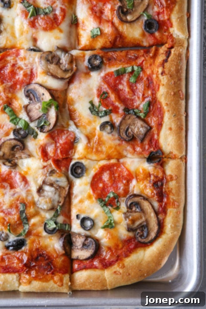Easy homemade sheet pan pizza fresh from the oven, with pepperoni and cheese