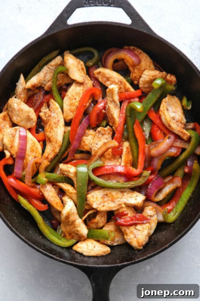 Close-up of sizzling chicken and vegetables for fajita filling
