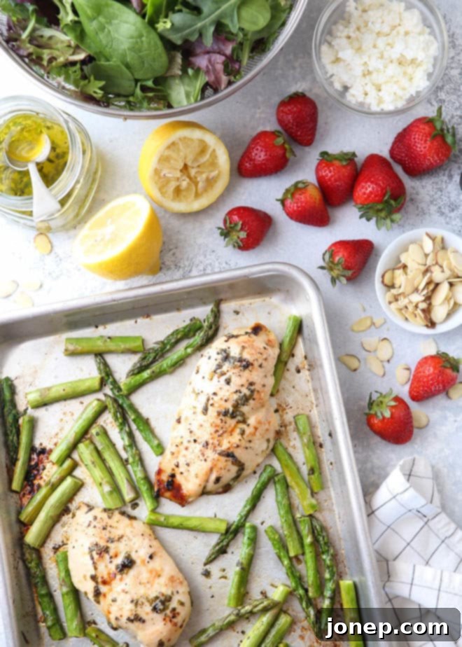 Close-up of a serving of strawberry asparagus chicken salad with dressing