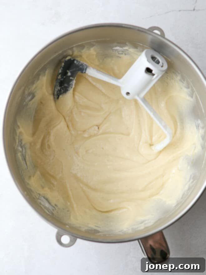 Classic Vanilla Cupcakes 5 Mixing vanilla cupcake batter in a stand mixer.