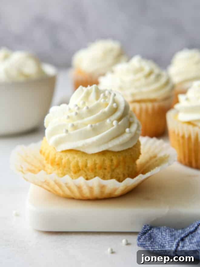 Classic Vanilla Cupcakes 9 Several frosted vanilla cupcakes arranged on a serving plate.