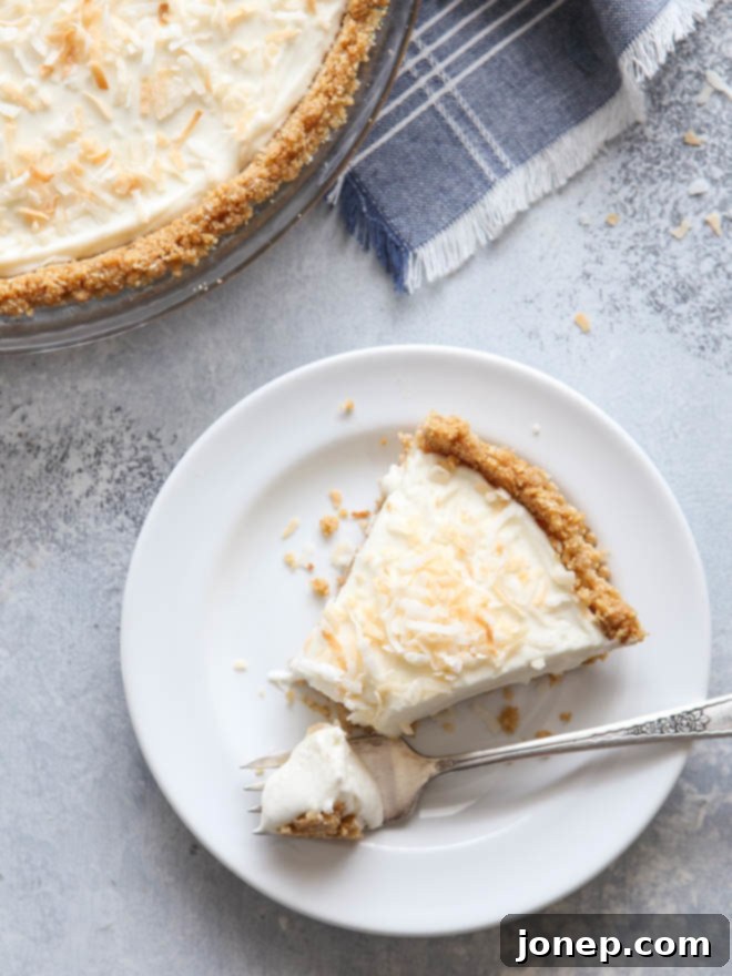 A slice of the dreamiest no-bake coconut cream pie, perfectly chilled and ready to enjoy.