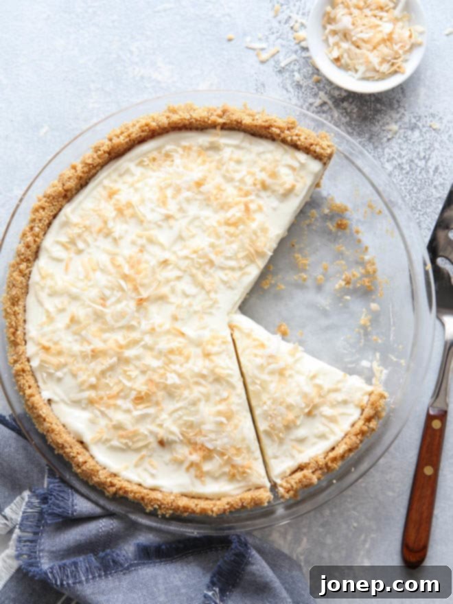 The dreamiest no-bake coconut cream pie, perfectly chilled and ready for slicing into generous portions.