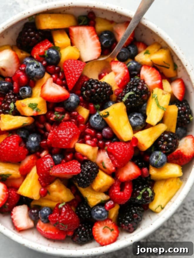 Luscious Berry Fruit Salad 2 View of a beautifully arranged fruit salad with fresh mint leaves and a hint of vanilla, ready to be served.