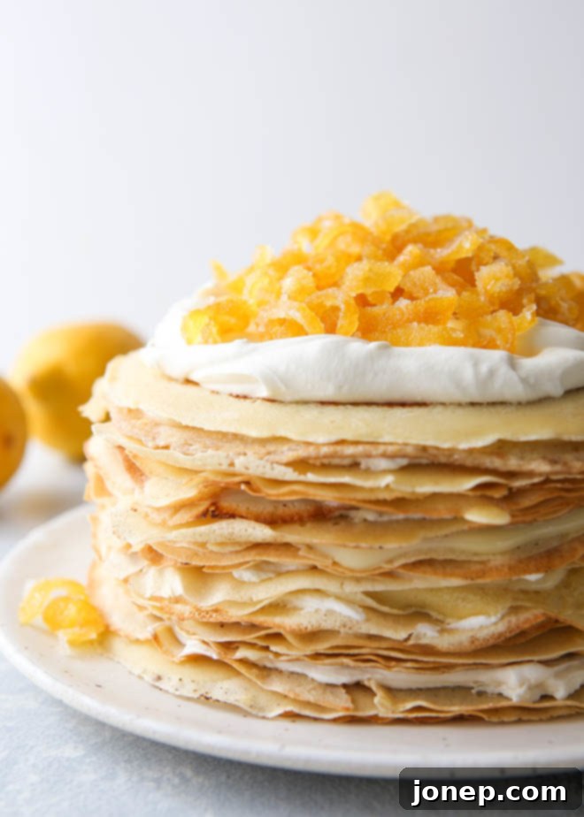 Close-up of a Lemon Mascarpone Crepe Cake, showing layers and candied lemon peel garnish