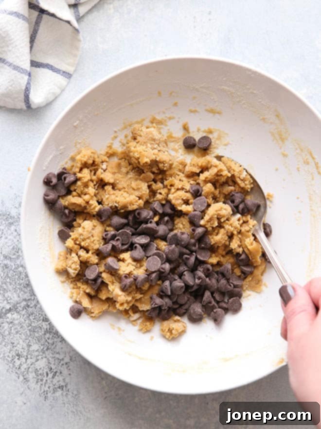 Mixing up one giant peanut butter chocolate chip cookie