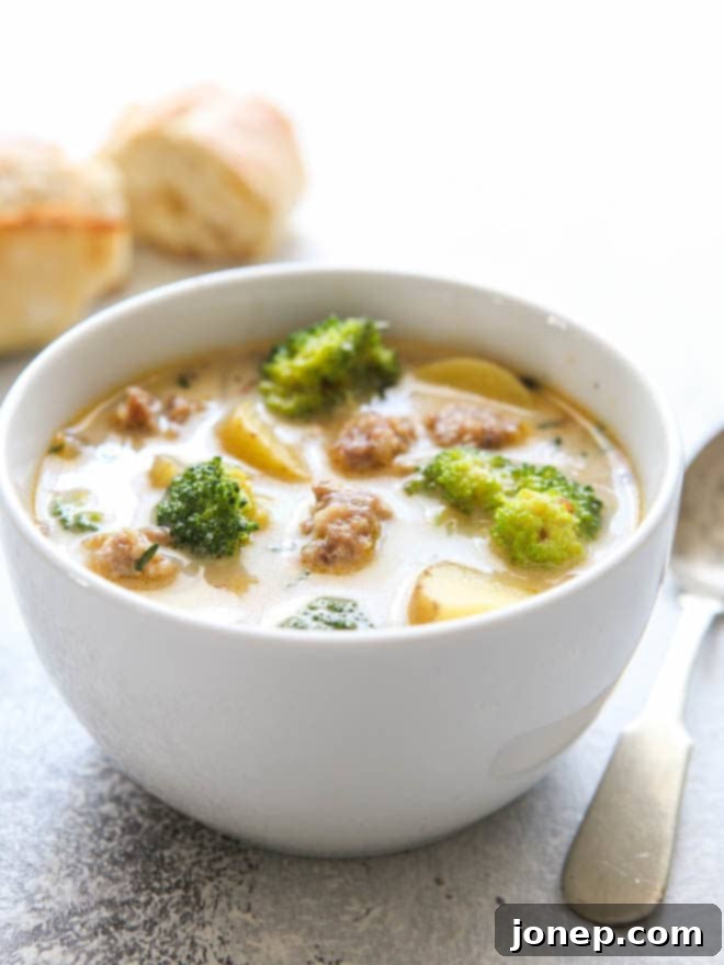 Cozy and satisfying sausage, broccoli, and potato soup in a rustic bowl.
