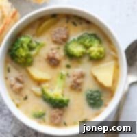 A bowl of hearty sausage, broccoli, and potato soup, ready to be enjoyed.