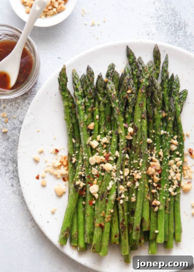 Sauteed asparagus dressed with a ginger-lime sauce and topped with peanuts