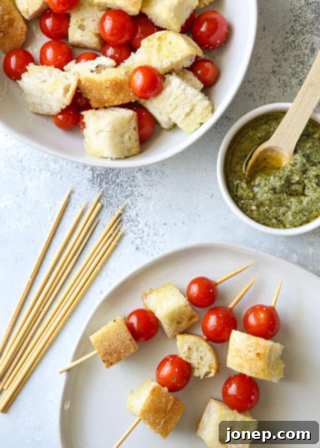 Charred Pesto Bruschetta Skewers 4 Assembling grilled bruschetta skewers with bread and cherry tomatoes.