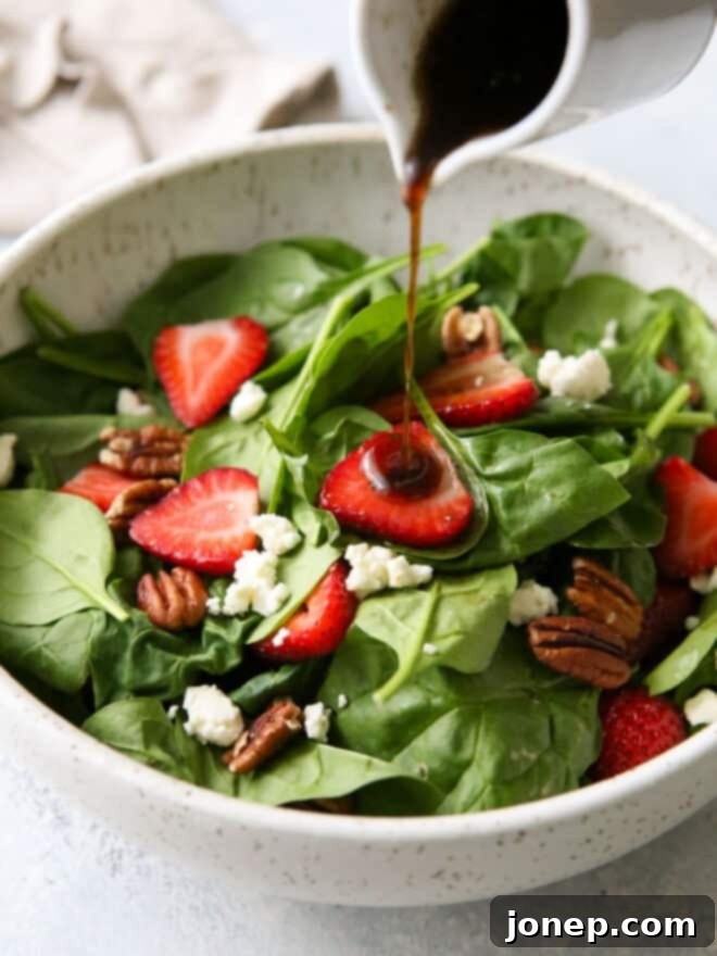 Warm Brown Butter Strawberry Spinach Salad 2 pouring warm brown butter dressing onto strawberry spinach salad
