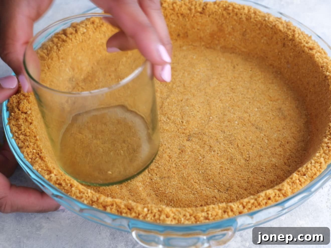 graham cracker crust going into pie pan