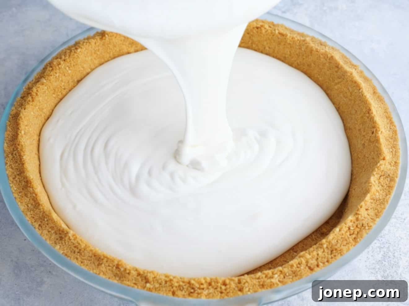 pouring ice cream filling into pie crust