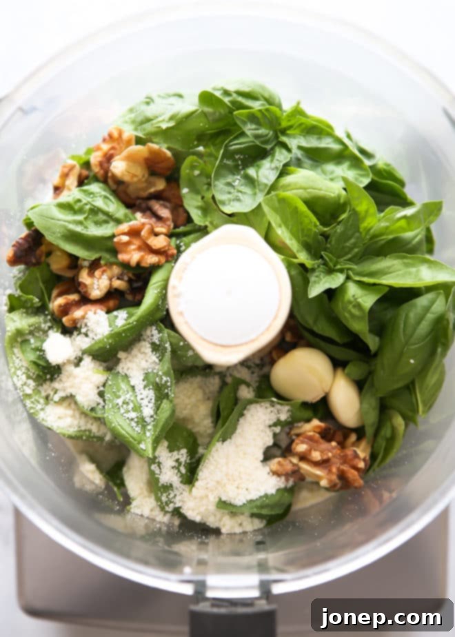 Process of making basil walnut pesto in a food processor, showing basil leaves and nuts being blended.