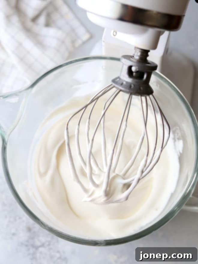 Achieve Flawless Whipped Cream 4 How to make perfectly whipped cream, showing cream being whipped in a stand mixer