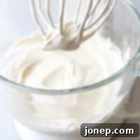 Achieve Flawless Whipped Cream 7 A bowl of perfectly whipped cream, ready to be served