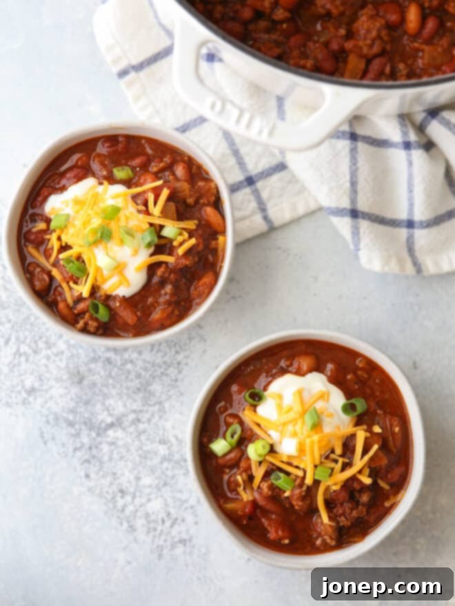 Effortless Weeknight Chili 6 Several bowls of easy homemade chili, generously topped with a variety of garnishes