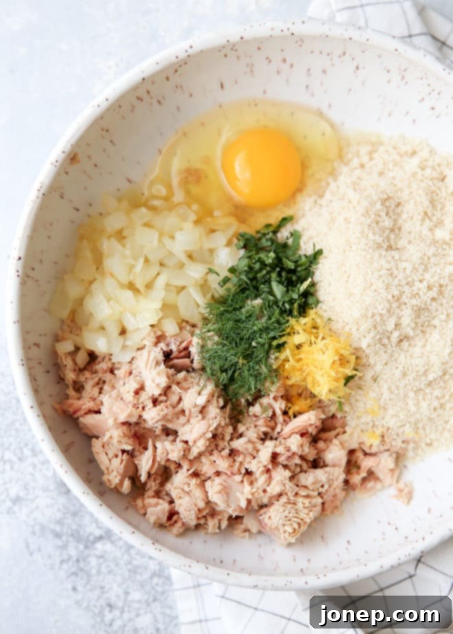 Mixing the ingredients for easy salmon patties in a bowl