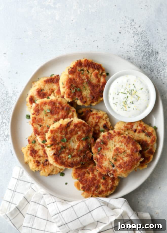 Close-up of golden brown salmon patties on a serving plate