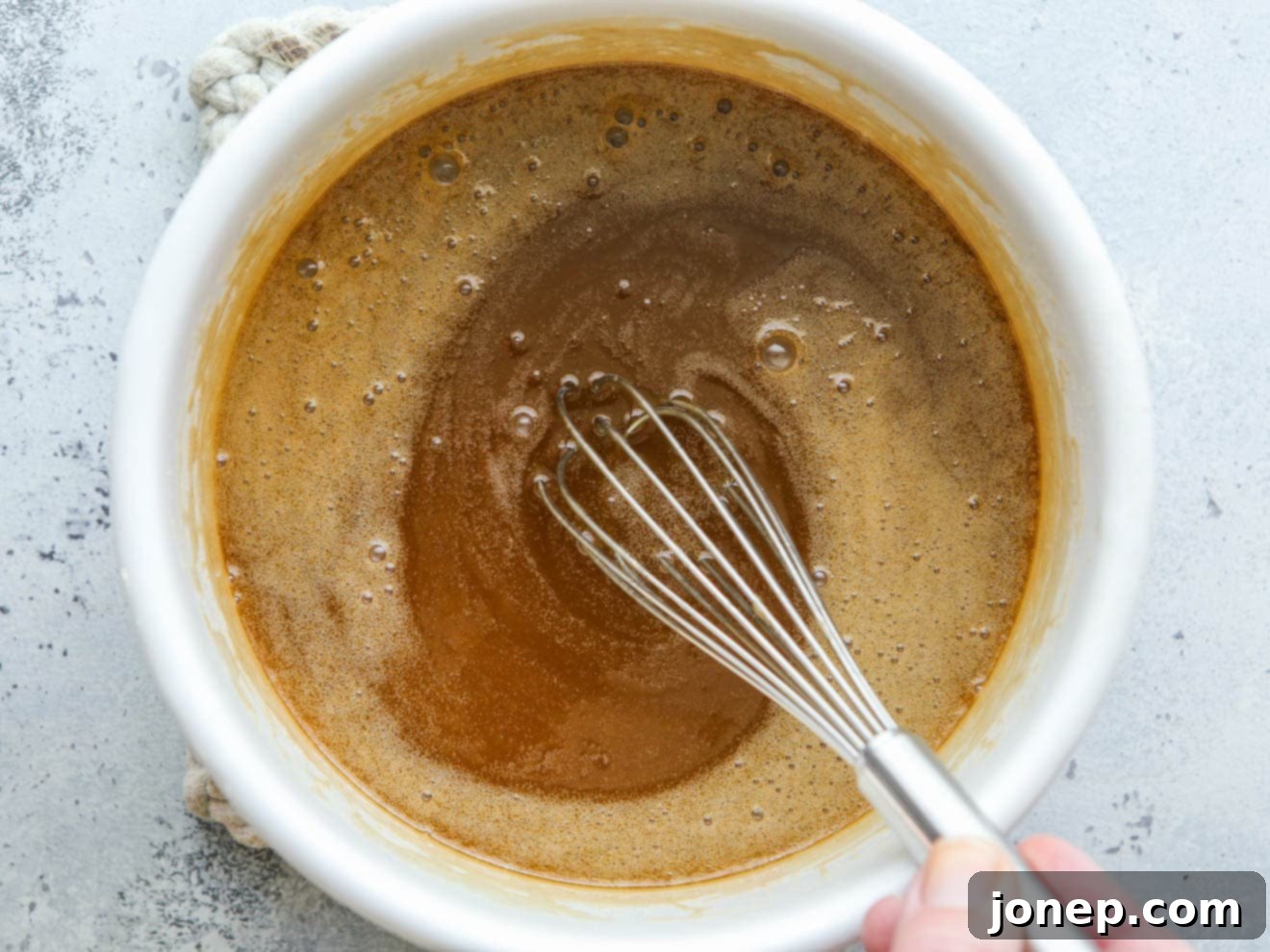whisking caramel sauce