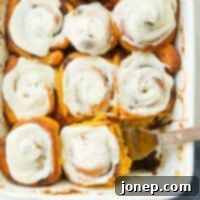 Cozy Fall Pumpkin Cinnamon Rolls 6 scooping pumpkin cinnamon