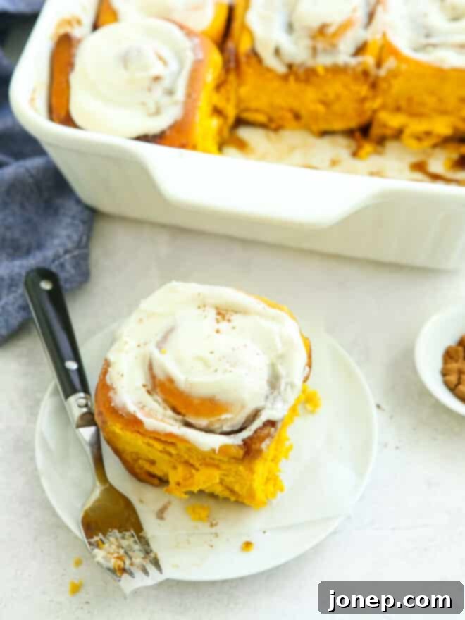 Cozy Fall Pumpkin Cinnamon Rolls 3 pumpkin cinnamon roll on a plate
