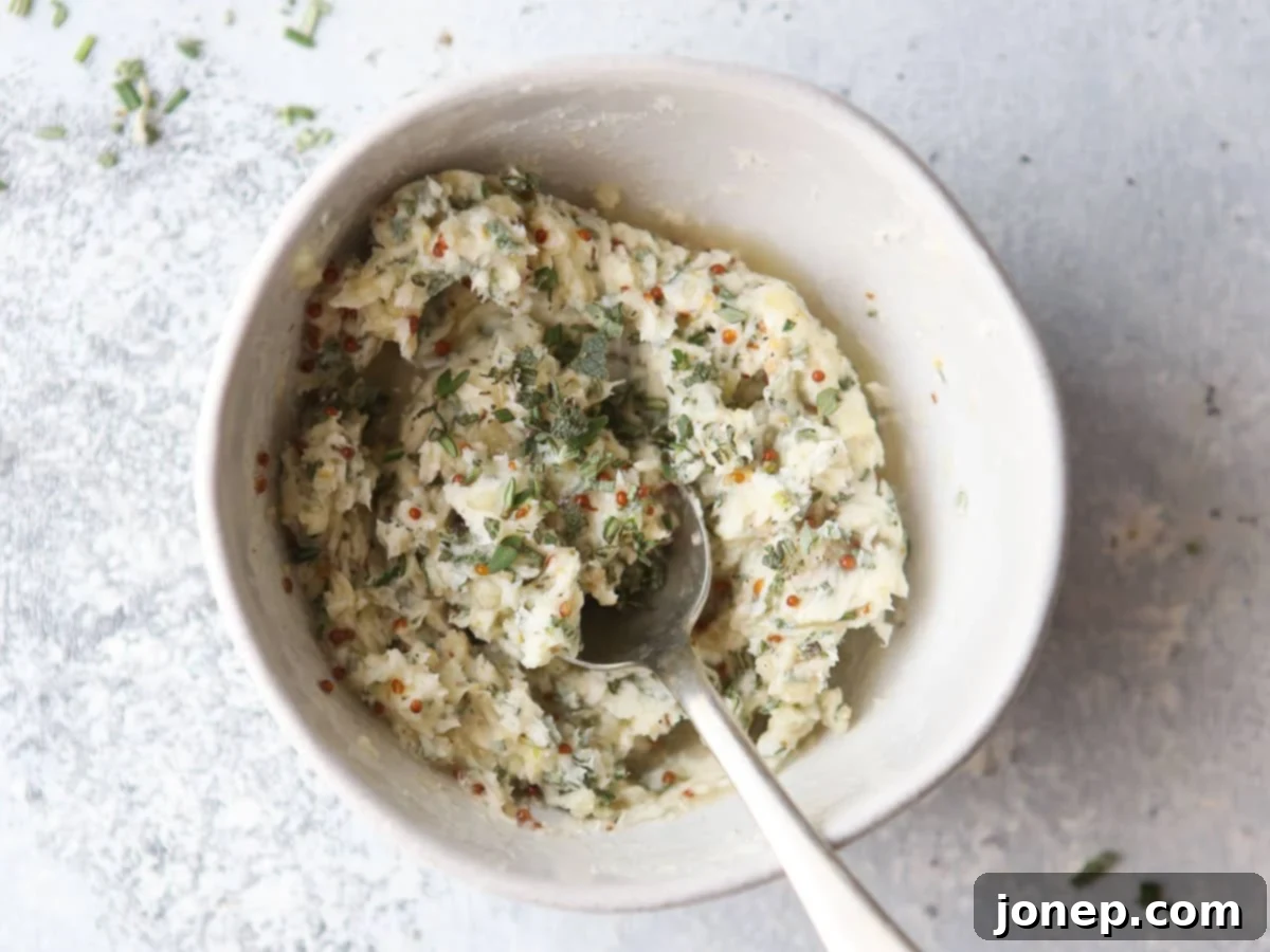 herb butter in a bowl, showing the rich texture and herb flecks