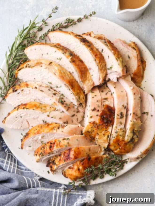 Aromatic Herb Roasted Turkey Breast 4 roasted turkey on a plate with herbs and gravy