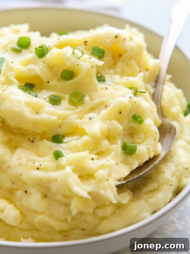 Master the Art of Creamy Fluffy Mashed Potatoes 3 close up of mashed potatoes in bowl with scallions