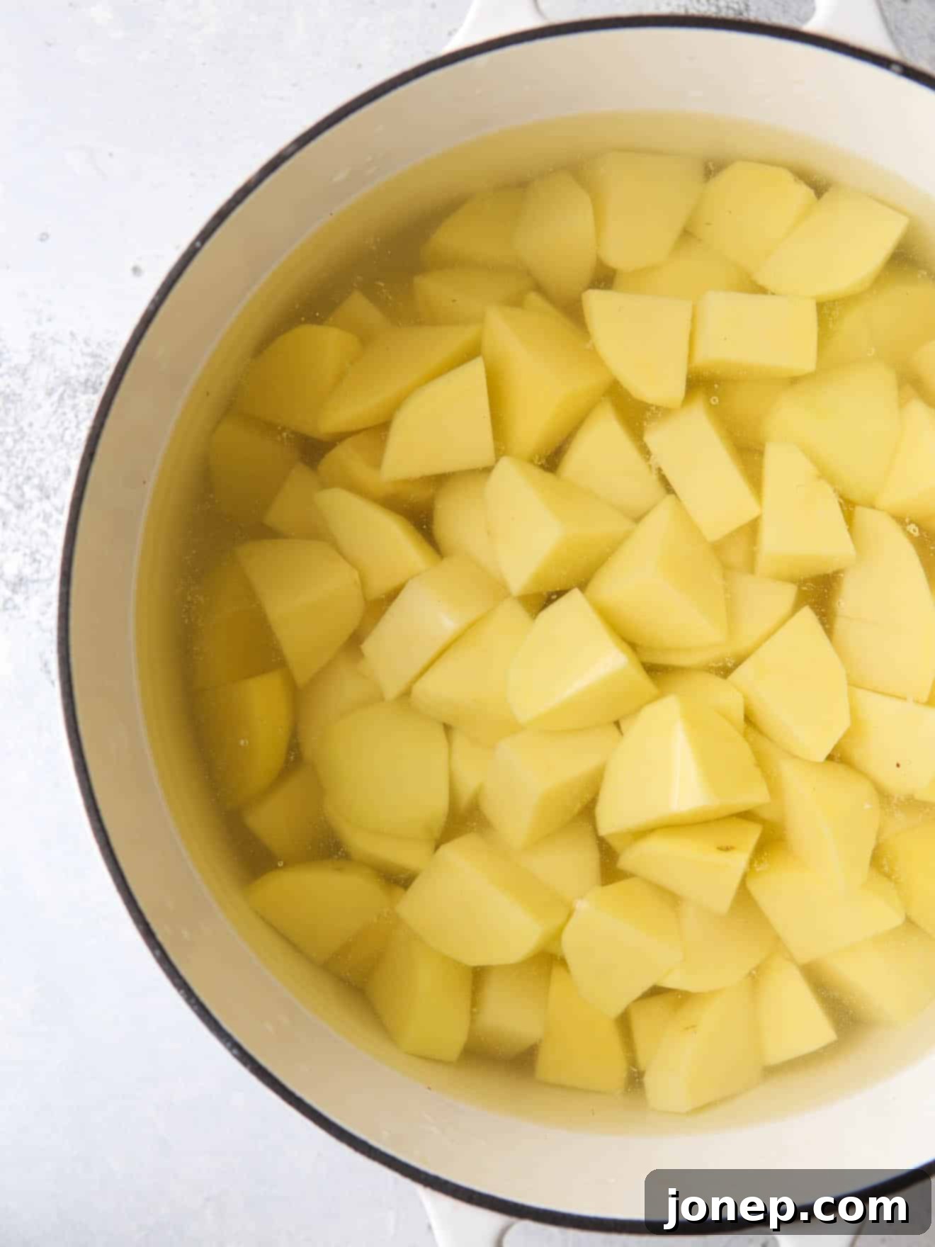 sliced potatoes in water in pot