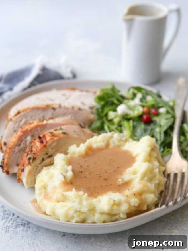 Perfect Homemade Turkey Gravy 3 A bowl of rich, brown homemade turkey gravy, with a ladle ready to serve, for a holiday meal.
