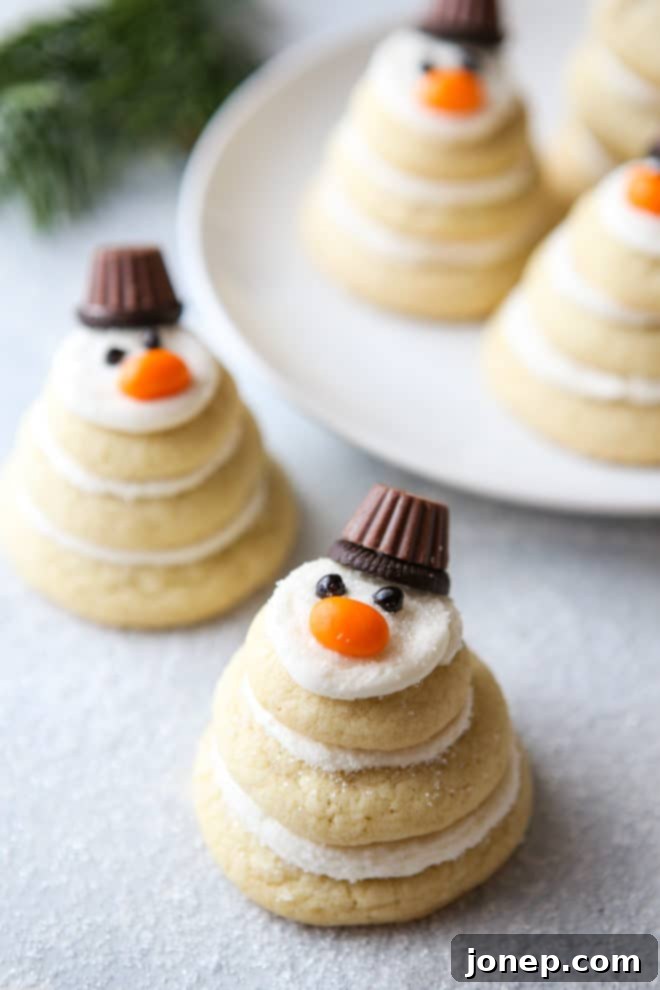 A beautifully arranged plate of decorated snowman sugar cookies for a holiday party