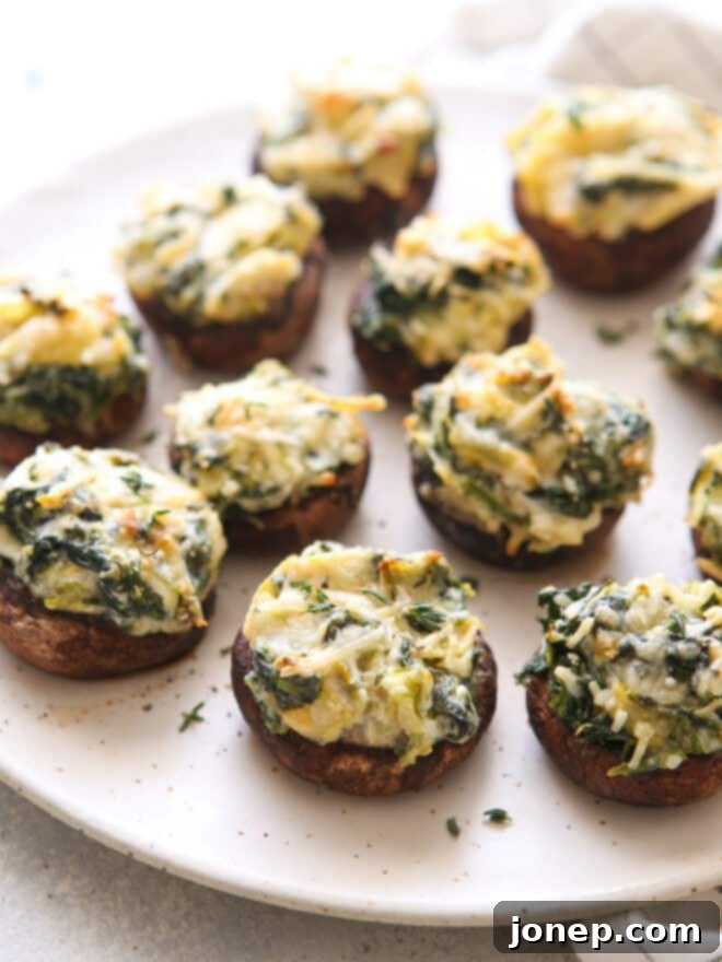 closeup of spinach artichoke stuffed mushrooms