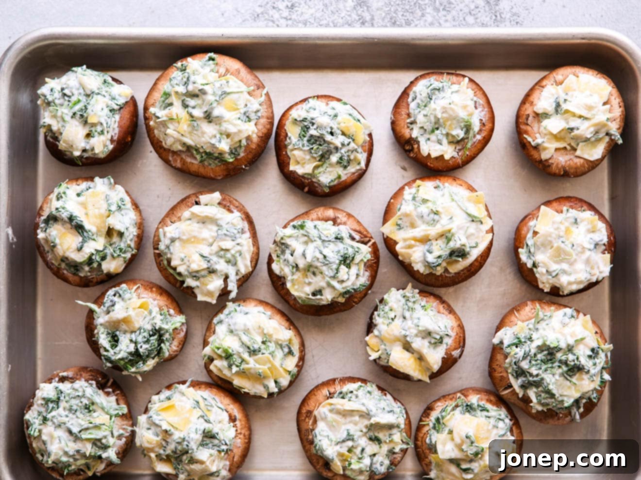 spinach artichoke mushrooms on a sheet pan for baking