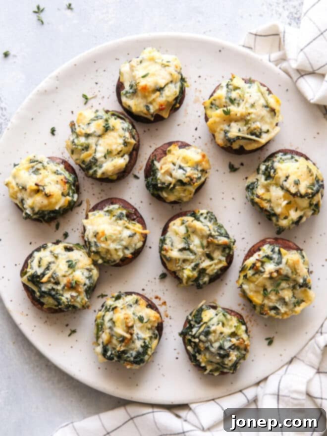 spinach artichoke stuffed mushrooms on a plate
