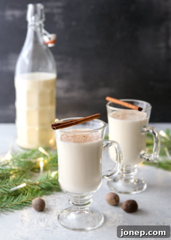 Fresh ingredients for homemade eggnog including milk, cream, eggs, nutmeg, and vanilla.
