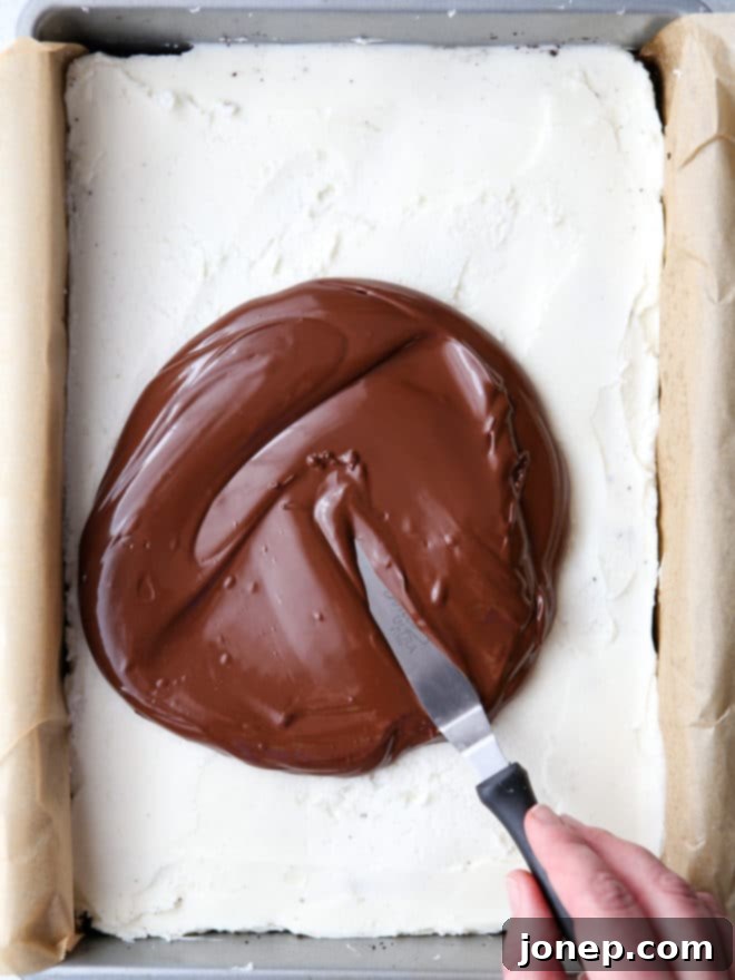 Spreading chocolate onto the peppermint bars