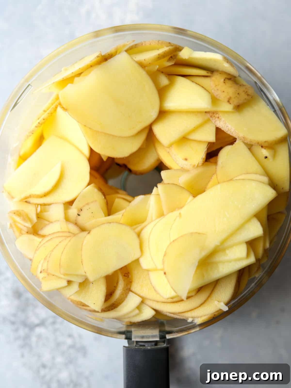 Thinly sliced potatoes, ready for layering in scalloped potatoes