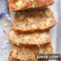 Tropical Pineapple Coconut Bread 5 This pineapple coconut bread is So flavorful and a little bit better for you! A perfectly sliced loaf showcasing the moist interior.