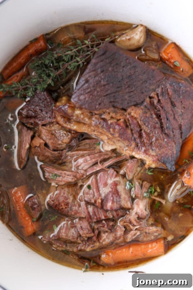 Pot roast cooked in the slow cooker is so tender and full of flavor, perfect for a comforting meal.