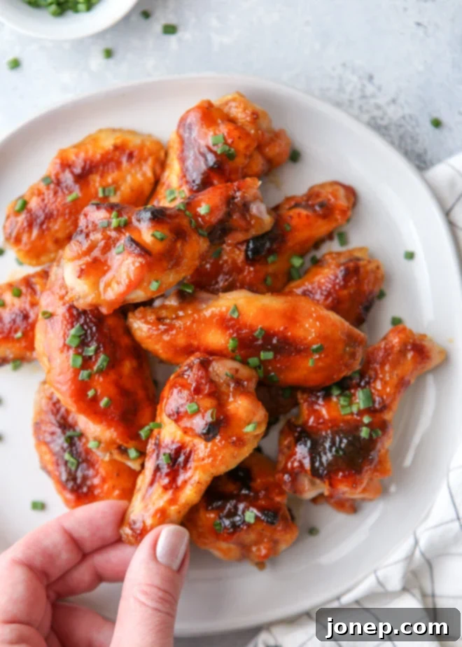 Oven-baked chicken wings glazed with a sweet and spicy maple sauce, served hot and crispy.