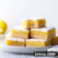Classic lemon bars with a buttery shortbread crust, tart lemon filling, and powdered sugar topping are a delightful dessert for any occasion!