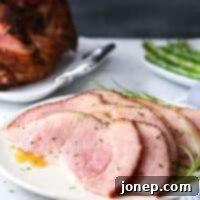 This honey-butter glazed ham recipe made with honey, butter, garlic, and rosemary is sweet and flavorful and only requires a few minutes of prep!