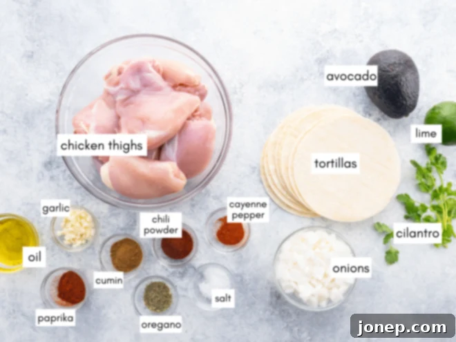 Fresh ingredients for shredded chicken tacos, including chicken thighs, spices, and olive oil.