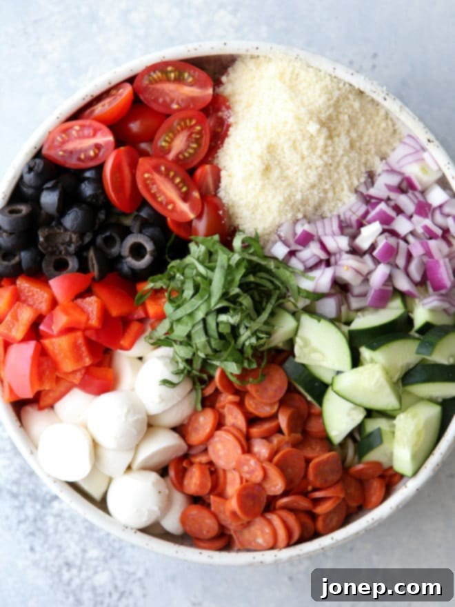 Classic Italian Pasta Salad 5 This quick and flavorful Italian pasta salad is filled with pepperoni, fresh mozzarella, bell peppers, tomatoes, cucumbers, olives and basil is perfect for potlucks and parties!