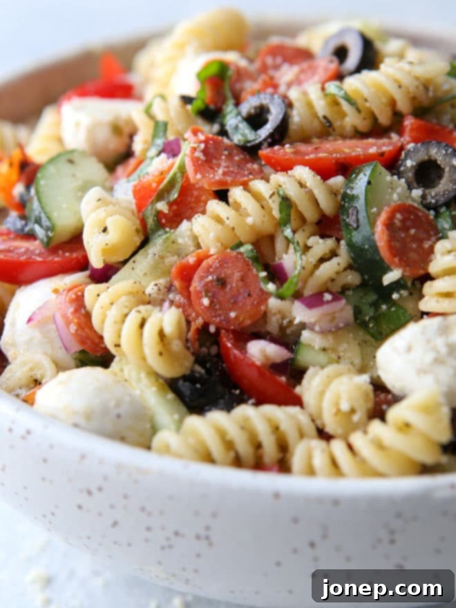 Classic Italian Pasta Salad 6 This quick and flavorful Italian pasta salad is filled with pepperoni, fresh mozzarella, bell peppers, tomatoes, cucumbers, olives and basil is perfect for potlucks and parties!
