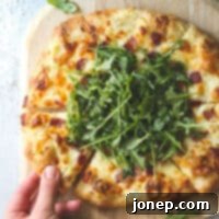 Savory White Pizza with Crispy Bacon and Fresh Arugula 6 This simple but irresistible three-cheese white pizza is topped with crispy bacon and fresh arugula for maximum flavor.